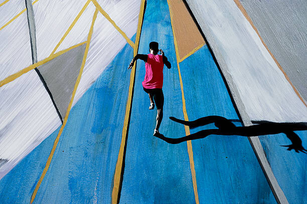 Umjetnička fotografija Male athlete sprinting, shot from above