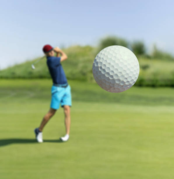 Umjetnička fotografija Man playing golf at club hitting the ball