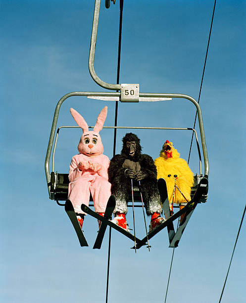 Photographie artistique People wearing animal costumes riding ski lift