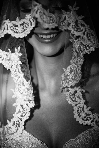Umělecká fotografie Smiling bride under the elegant translucent veil