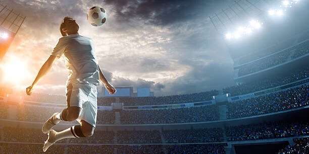 Umetniška fotografija Soccer player kicking ball in stadium