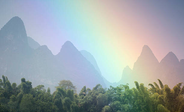 Umelecká fotografie View of rainbow by mountains.