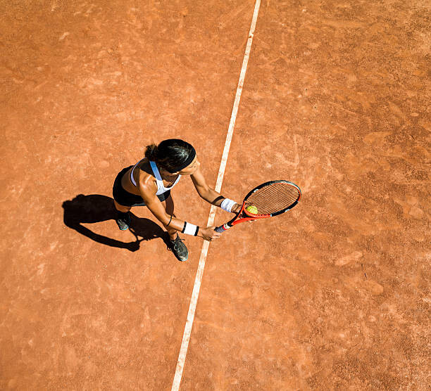 Fotografia artystyczna Woman tennis player about to hit a serve