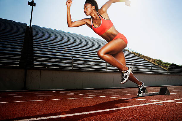 Konstfotografering Women running on athletic track