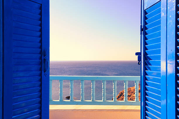 Samolepka Blue Shutters Open onto Sea and Sky at Dawn