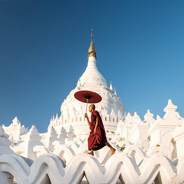 Samolepka Buddhist monk walking across arches of temple