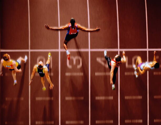 Schilderij op canvas Athletes in race crossing finishing line,