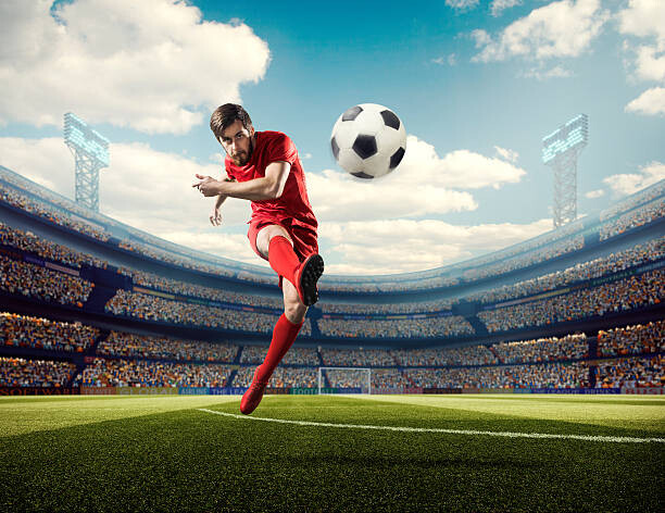 T-shirt Soccer player kicking ball in stadium