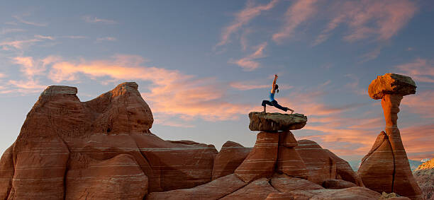 Behang Caucasian woman practicing yoga on top