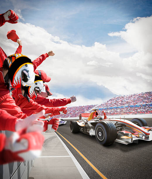 Fototapet Pit crew cheers for winning driver