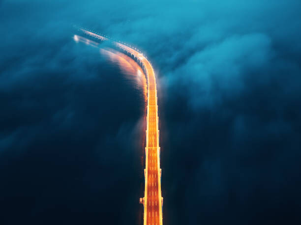 Fototapeta A cross-sea bridge in the fog at night