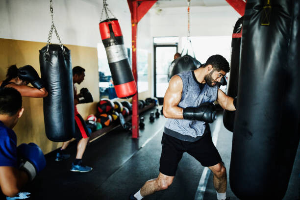 Fototapeta Male and female boxers working out