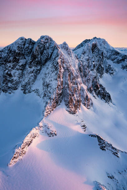 Fototapeta Pink sunrise over snowcapped mountains, Italy