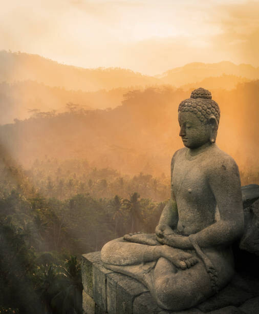 Fototapeta Statue of Buddha at sunset, Borobudur,