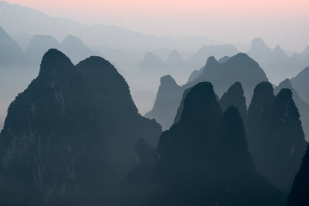 Fototapeta Sunrise behind mountains landscape in Xingping