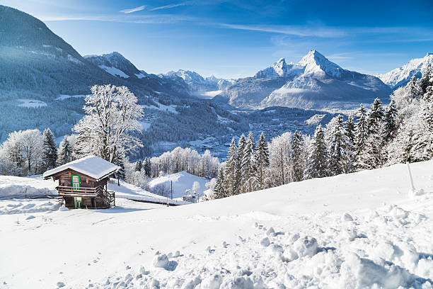 Fototapeta Winter wonderland with mountain chalet in the Alps