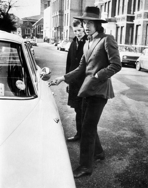 Samolepka Jagger, singer with the Rolling Stones, about to get into his car, c.1970