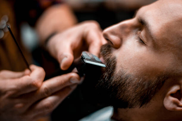 Billede på lærred Man getting his mustache shaped by
