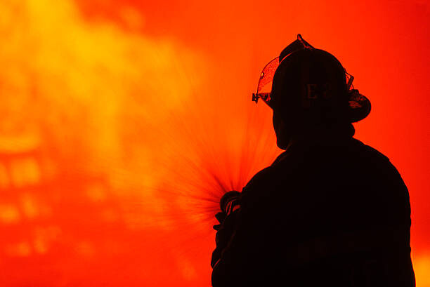 Bild auf Leinwand Silhouetted fireman