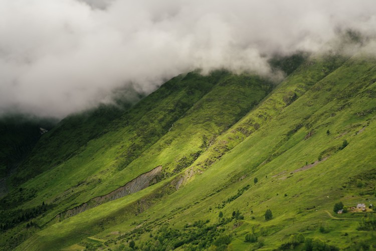 Fotografie de artă Clouds over the green valley