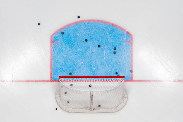 Obraz na plátně Hockey Net with Pucks from Above