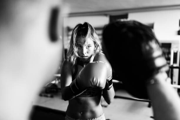 Obraz na plátně Woman boxer workout with coach