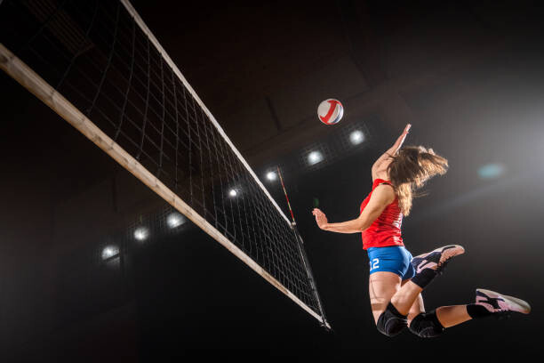 Obraz na plátně Woman spiking volleyball
