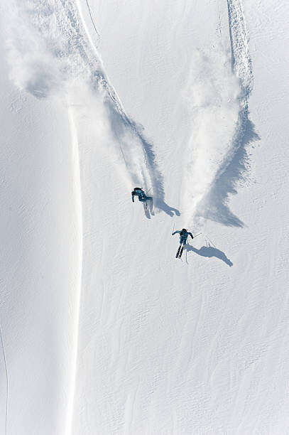 Obraz na plátně Aerial view of two skiers skiing