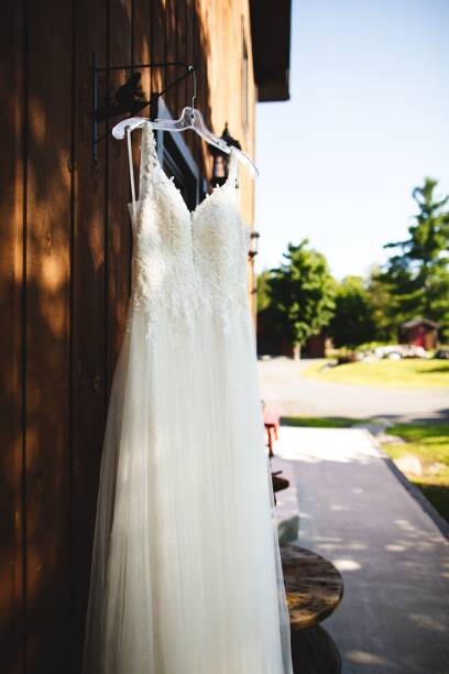 Obraz na plátně Beautiful white wedding dress hanging elegantly
