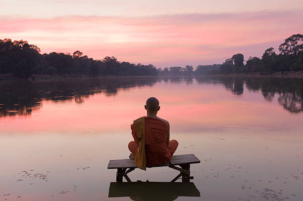 Obraz na plátně Cambodia, Angkor Wat, Buddhist Monk at sunset