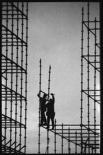 Obraz na plátně Construction Workers Building Scaffolding