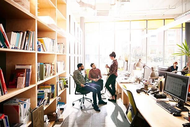 Obraz na plátně Creative coworkers chatting over ideas in office