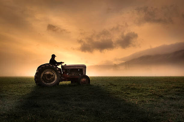 Obraz na plátně Farmer riding tractor