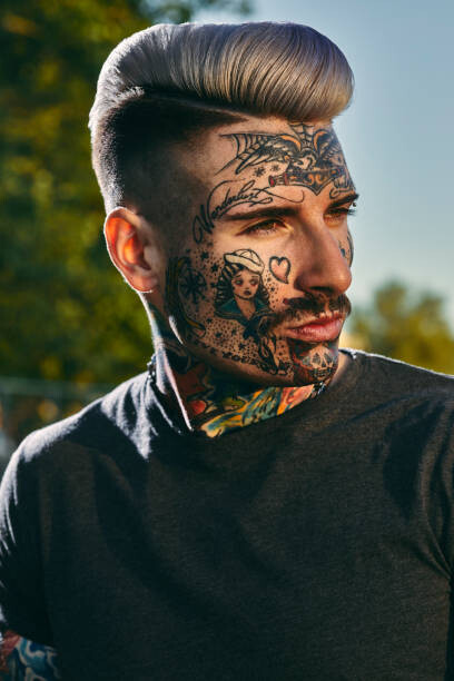 Obraz na plátně Portrait of tattooed young man outdoors