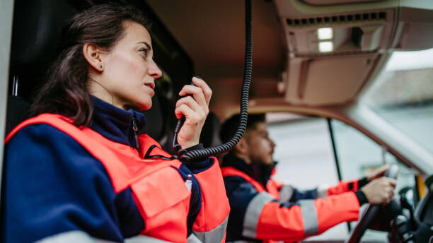 Obraz na plátně Rescuers sitting in ambulance, preparing for