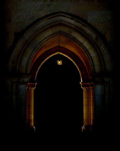Obraz na plátně Stone archway lit by lantern