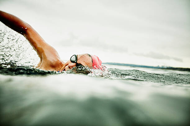 Obraz na plátně Woman taking a breath during open water swim