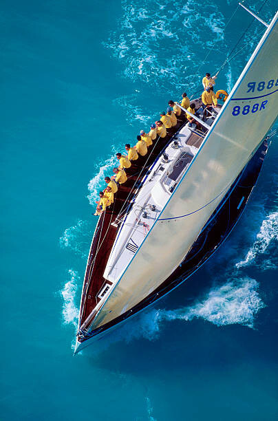 Cuadro en lienzo Sailing Team Sitting on Edge of Boat