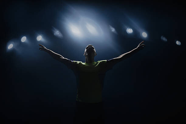 Plakat Soccer player shouting in stadium, victorious