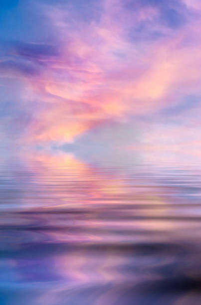 Plakat Sunset over a water surface with waves.