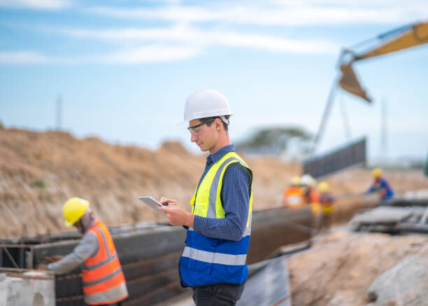 Plakát Male engineer or technician and tablet