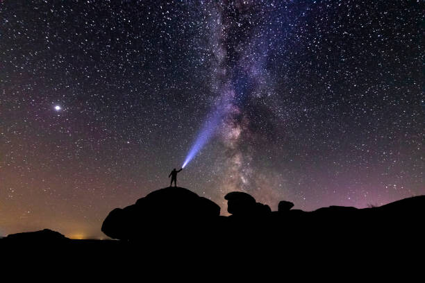 Plakát Man with a flashlight on the