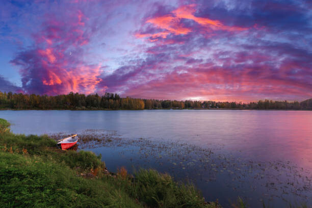 Plakat A rowboat on the beach. Sunset