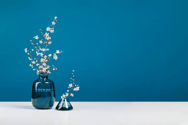 Plakát Blue glass vases with bouquet of
