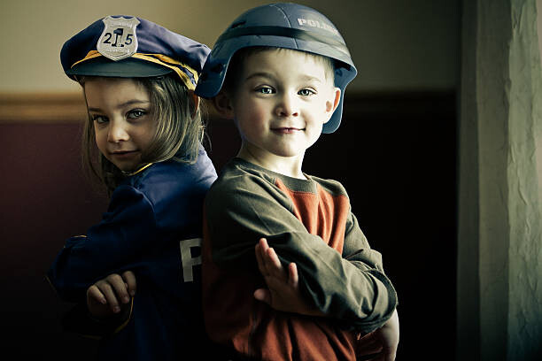Plakát Boy and girl twins dressed up as police officers