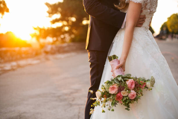 Plakát Bride and groom hugging with wedding