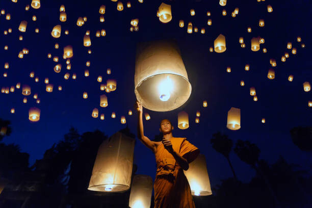 Plakát Buddhist Monk releasing lanterns into sky