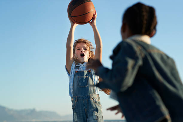 Plakát Children together playing on beach by the ocean