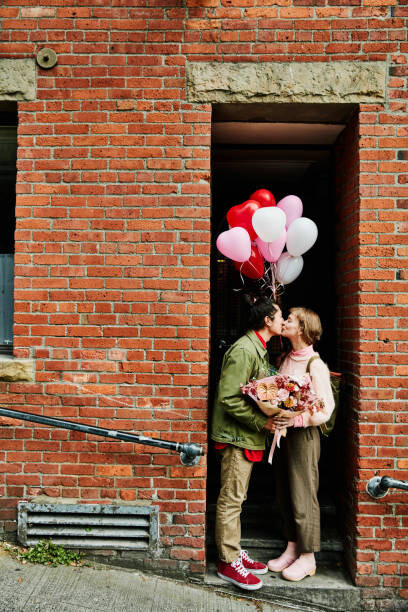 Plakát Couple kissing in doorway while on