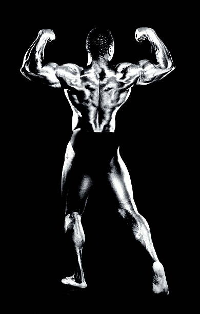 Plakát Male bodybuilder flexing muscles, rear view (B&W)